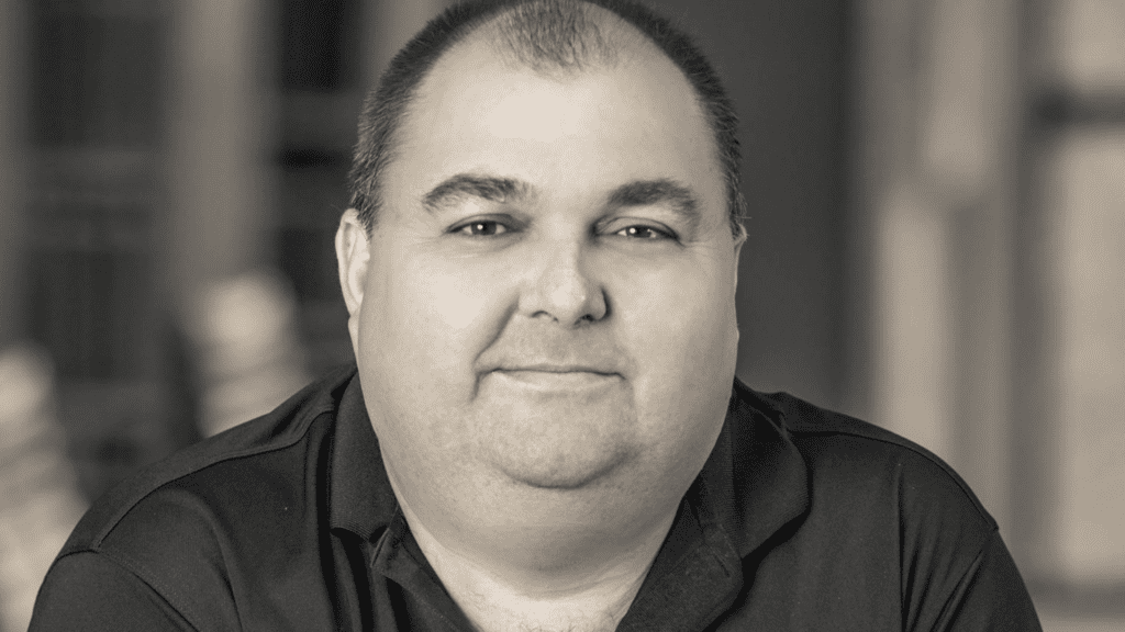 Image of author James Ponti. The image is black and white with Jame breaking a small smile.